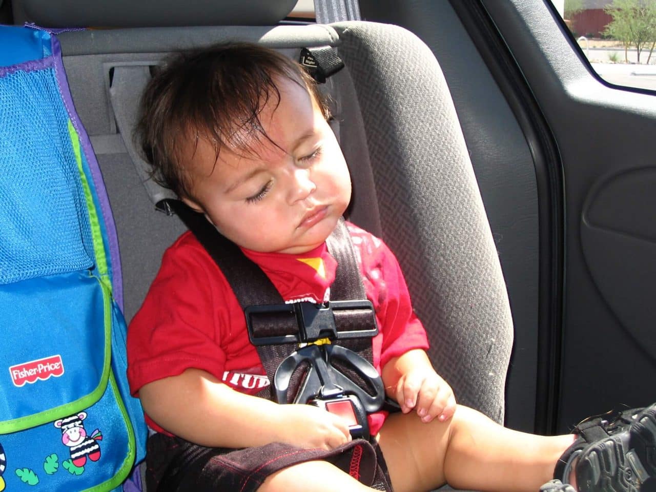 Toddler sleeping in a built-in car seat