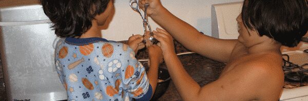 Two young children making meatballs
