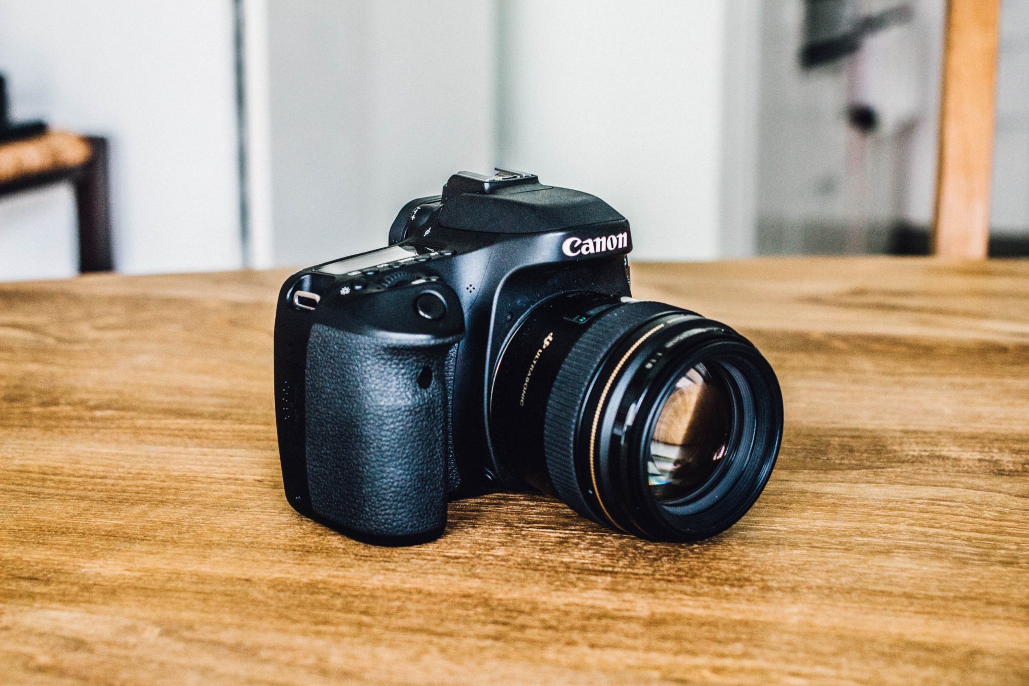 Canon camera sitting on a wooden table