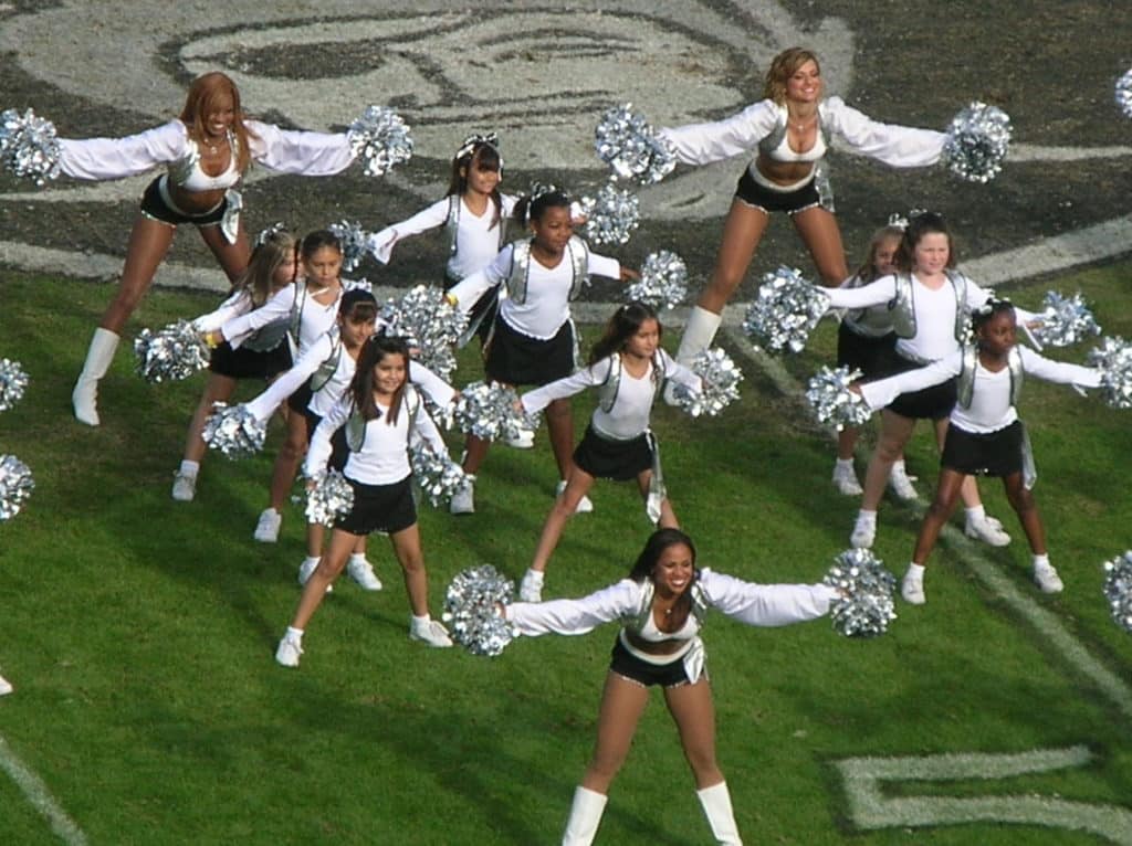 Photo of Raiderettes and Junior Raiderettes on the field