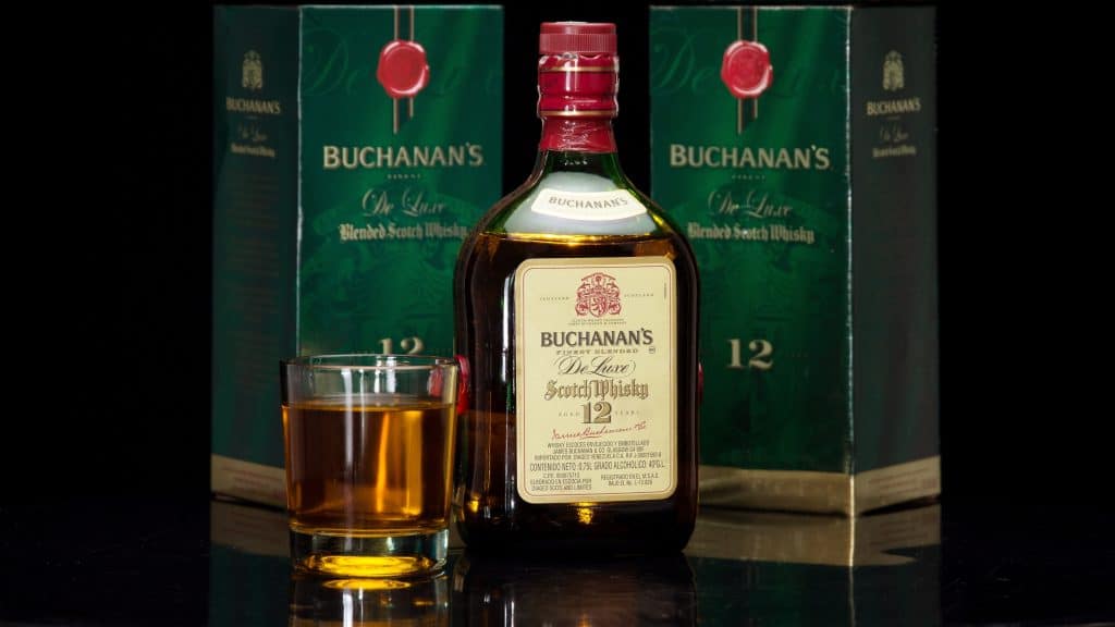 Buchanan's Deluxe Scotch Whisky bottle with glass