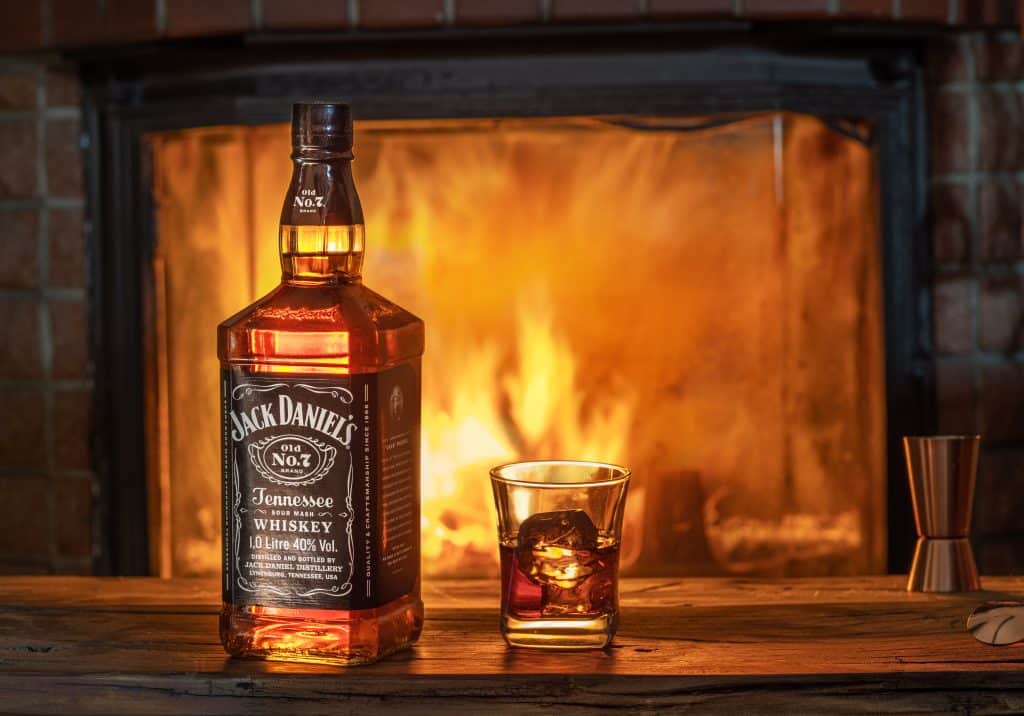 Jack Daniels bottle next to a fire