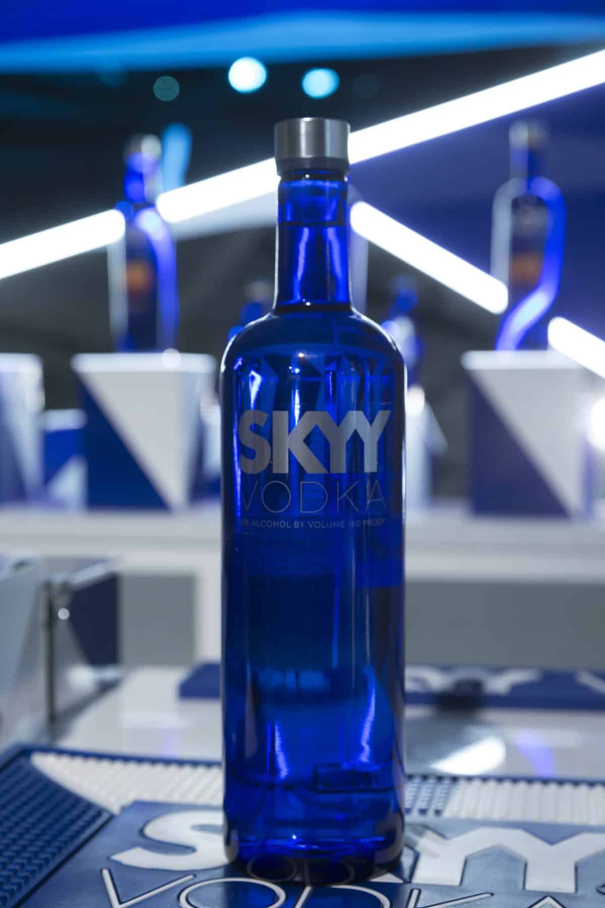 bottle of Skyy Vodka with a mirror behind it while sitting on a counter