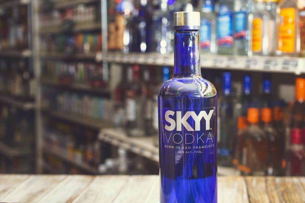 Skyy Vodka bottle on a wooden table